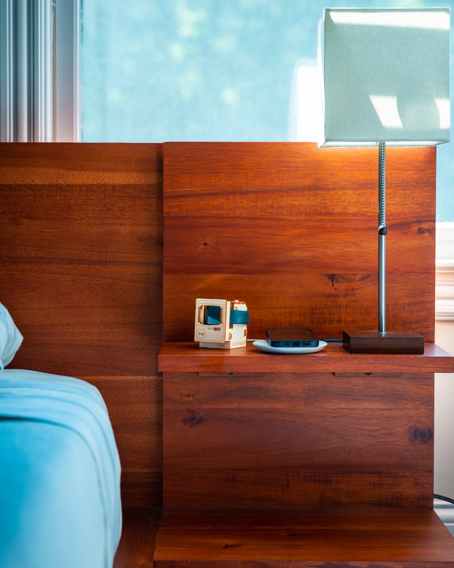 retro computer desk decor used as Apple Watch charging station on modern bedside table