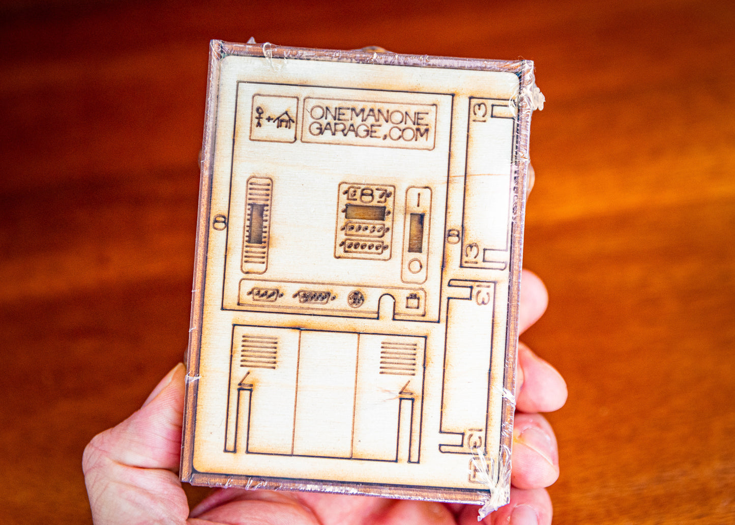 flat-packed miniature computer desk decor kit held in hand showing compact size