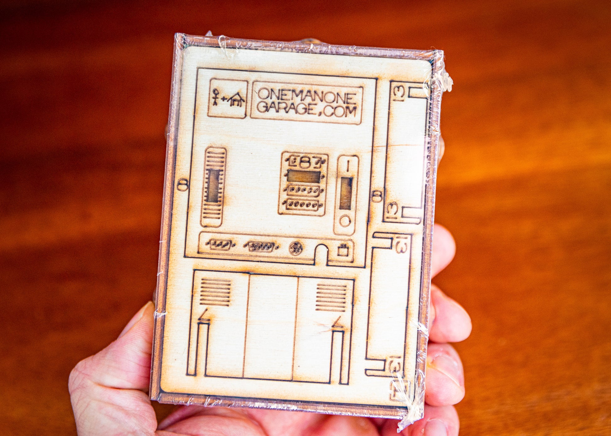 flat-packed miniature computer desk decor kit held in hand showing compact size