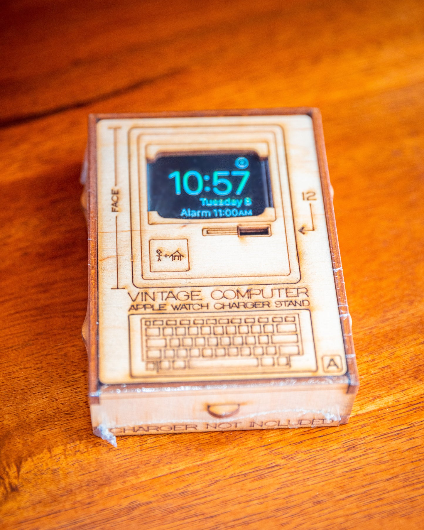front packaging artwork for retro computer Apple Watch charging stand with engraved product illustration
