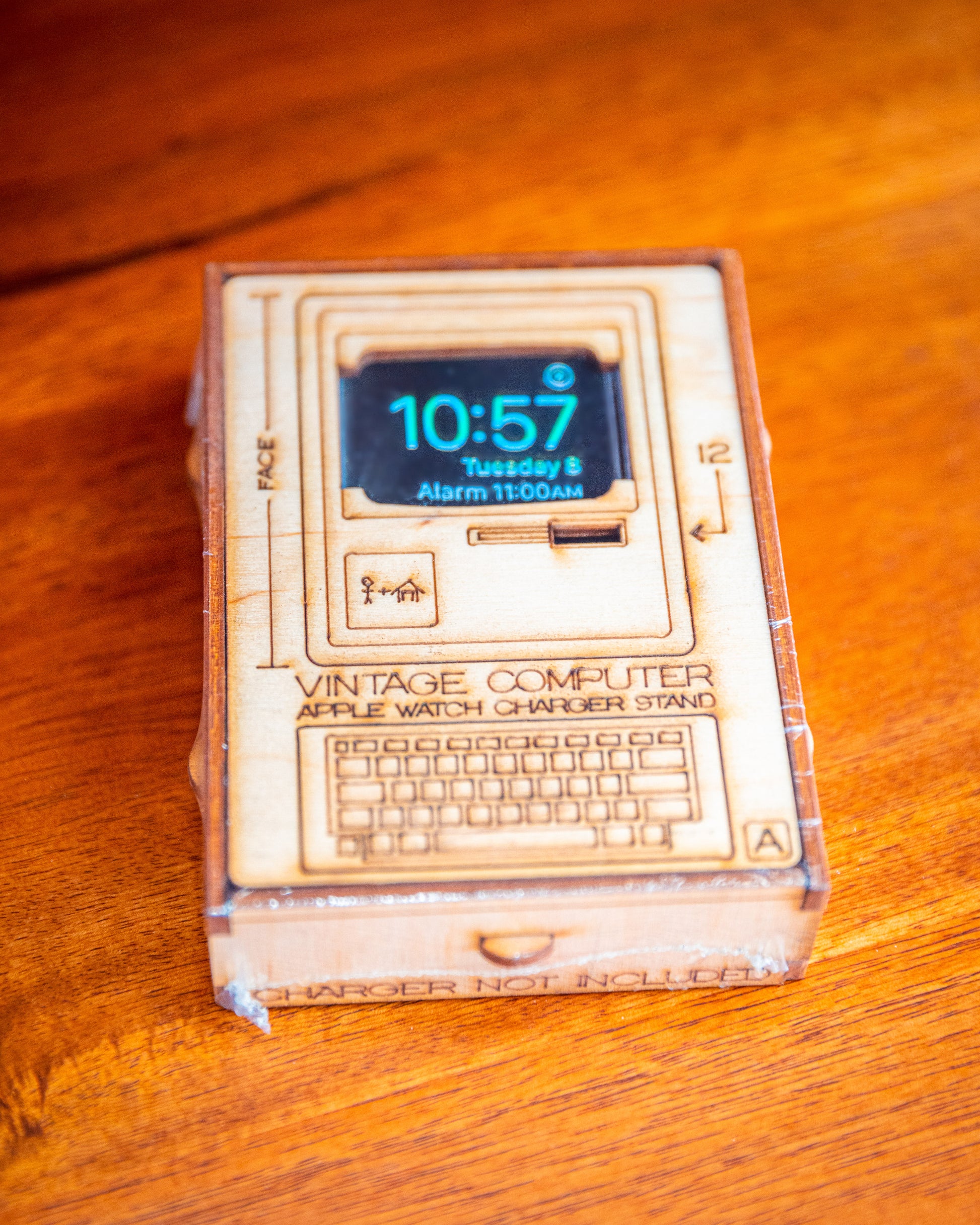 front packaging artwork for retro computer Apple Watch charging stand with engraved product illustration
