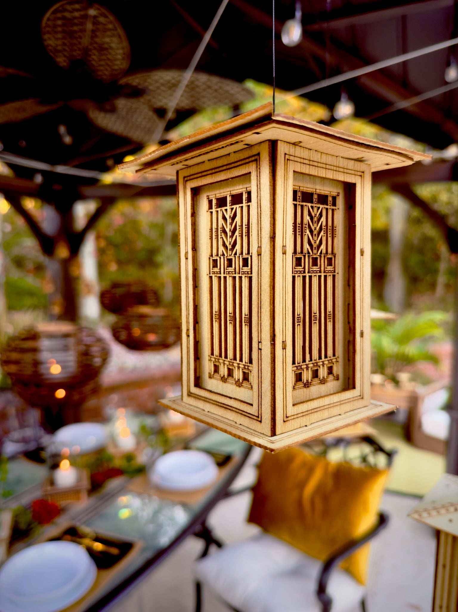wooden Prairie lantern suspended above outdoor gathering space as decorative ambient lighting