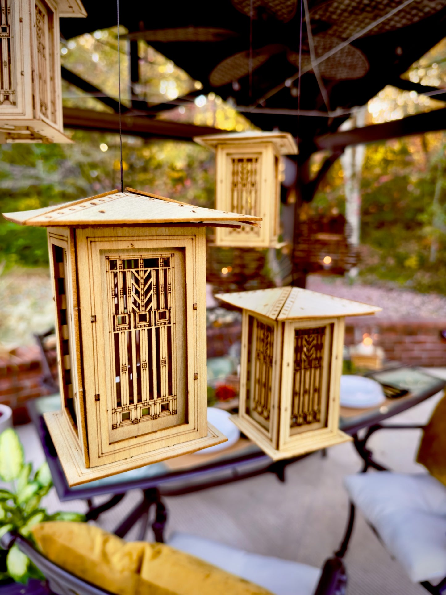 Multiple hanging Prairie style lanterns displayed together in an outdoor entertaining area