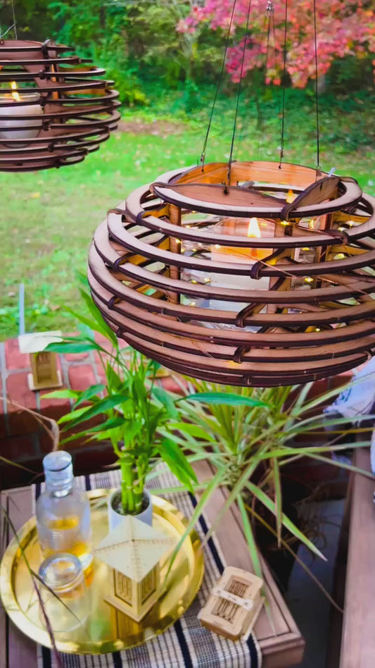 video of hanging Nest lantern swaying gently in daylight, showcasing its nature-inspired design and warm ambient glow