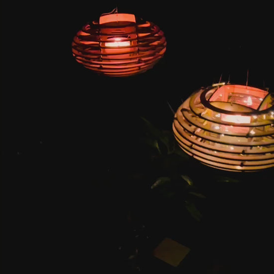 video of illuminated Nest lanterns hanging outdoors at night, creating a warm and relaxing atmosphere