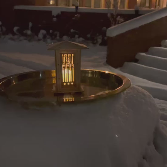 video of Wright prairie lantern illuminated outdoors, showcasing its warm glow and architectural design from multiple angles