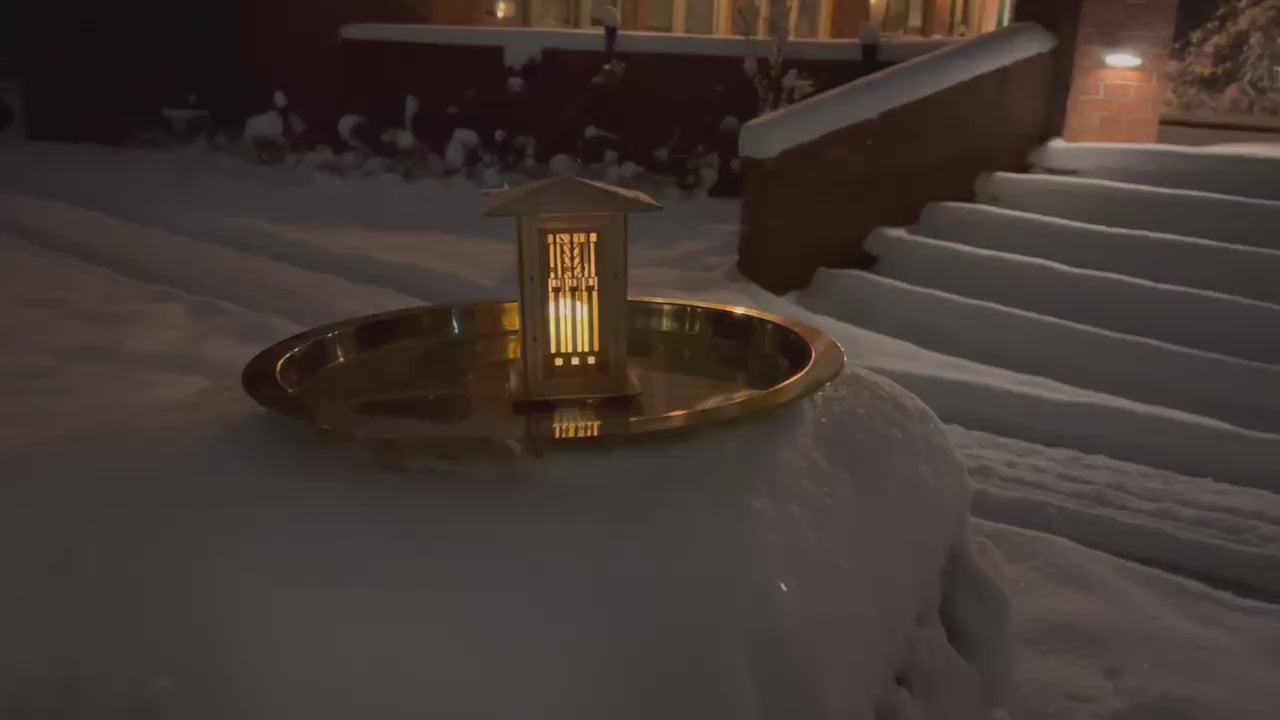 video of Wright prairie lantern illuminated outdoors, showcasing its warm glow and architectural design from multiple angles