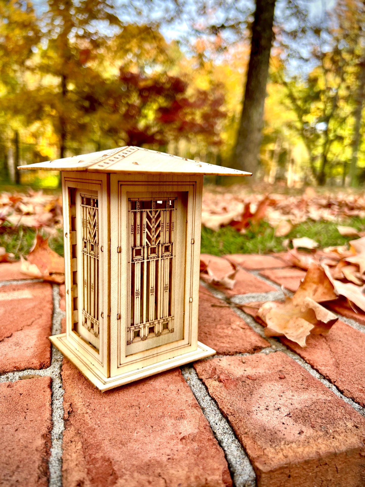 Arts and Crafts inspired wooden lantern displayed outdoors on brick walkway in autumn