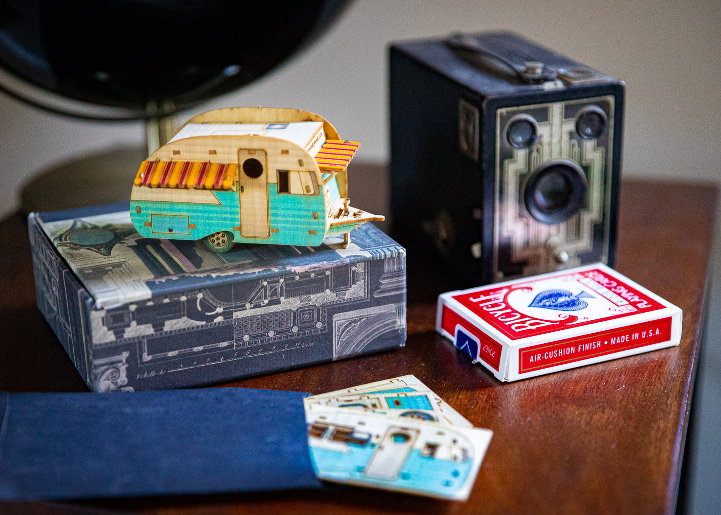 A miniature camper displayed on desk as decorative accent piece