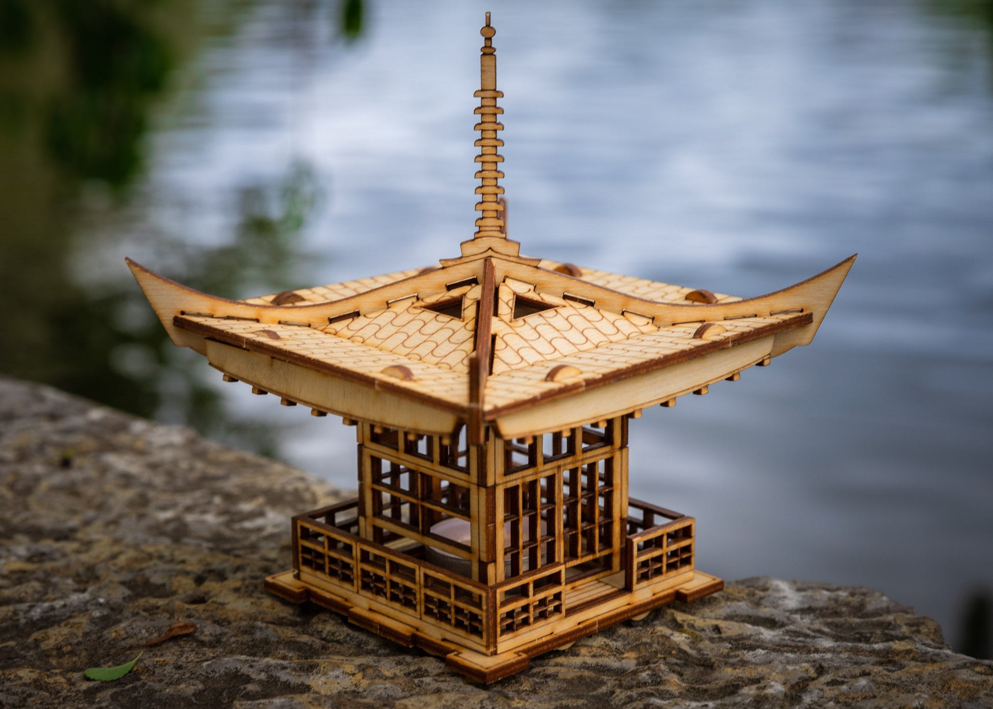 Top view of DIY wooden lantern kit showing intricate roof design and layered wood structure