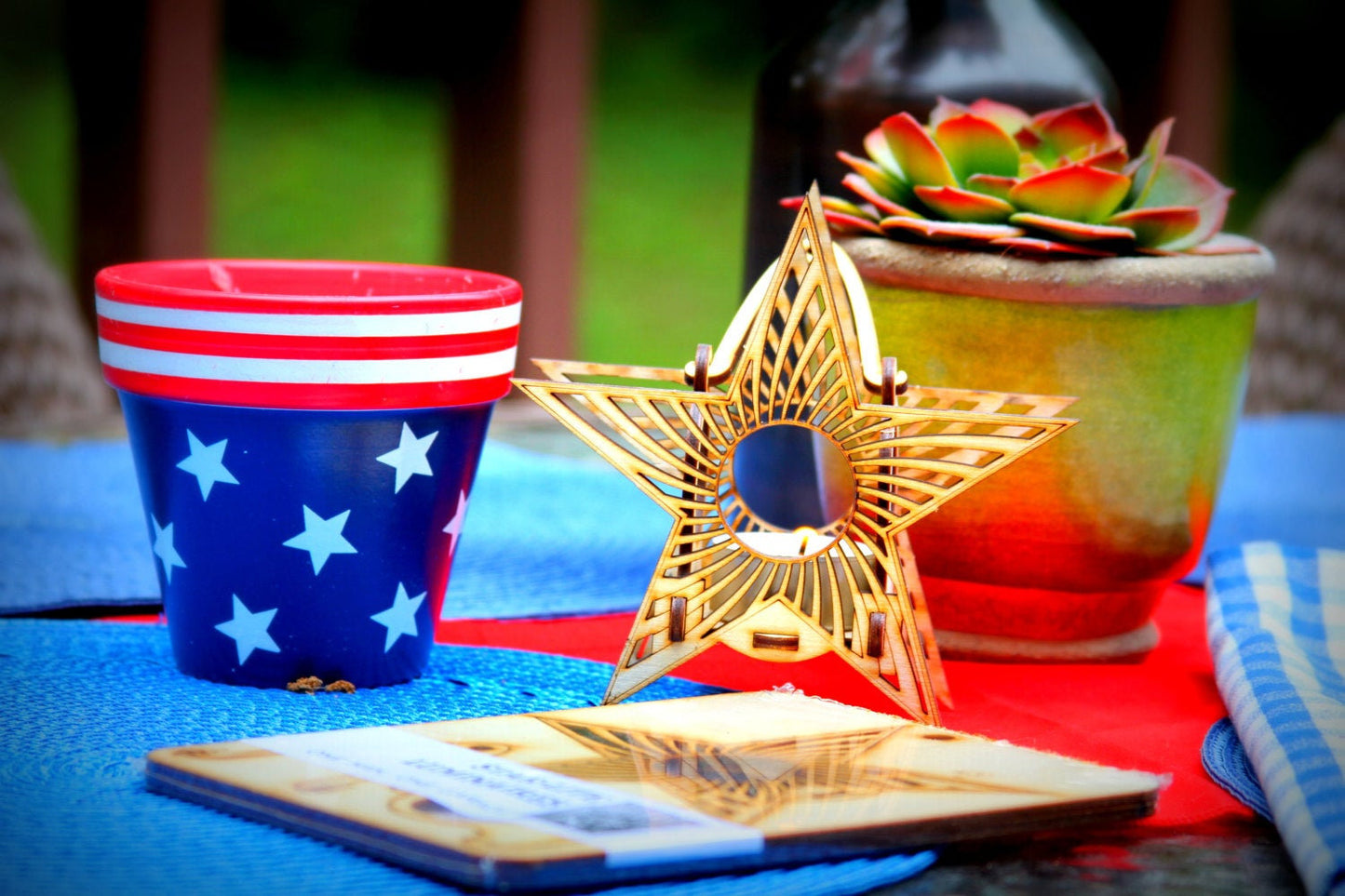 decorative wooden star luminaire beside candle and succulent in cozy tabletop arrangement