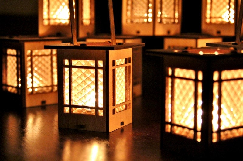 cluster of bungalow luminaires casting warm ambient light through geometric window panels