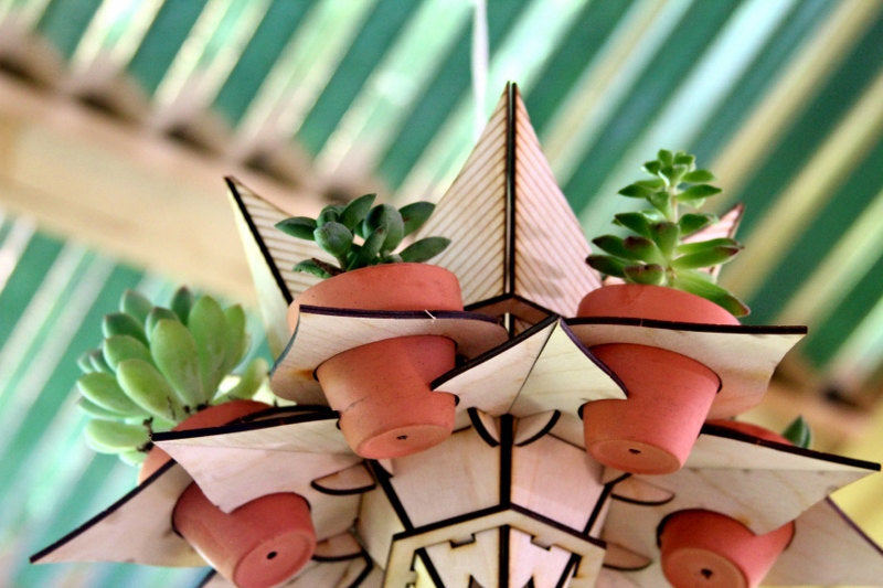 underside view of geometric hanging planter showing layered wood structure and terracotta pot arrangement
