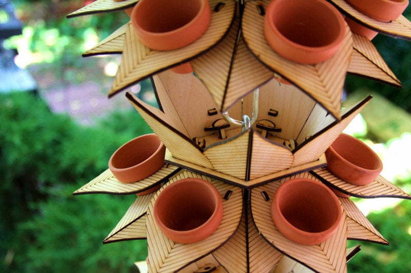 vertical garden tower with stacked terracotta pots and geometric wooden tiers viewed from above